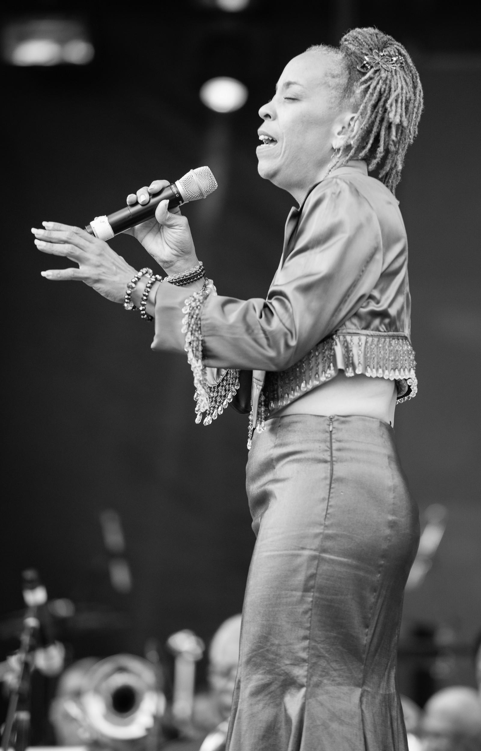 Black-and-white full-length photo of Maggie Brown singing