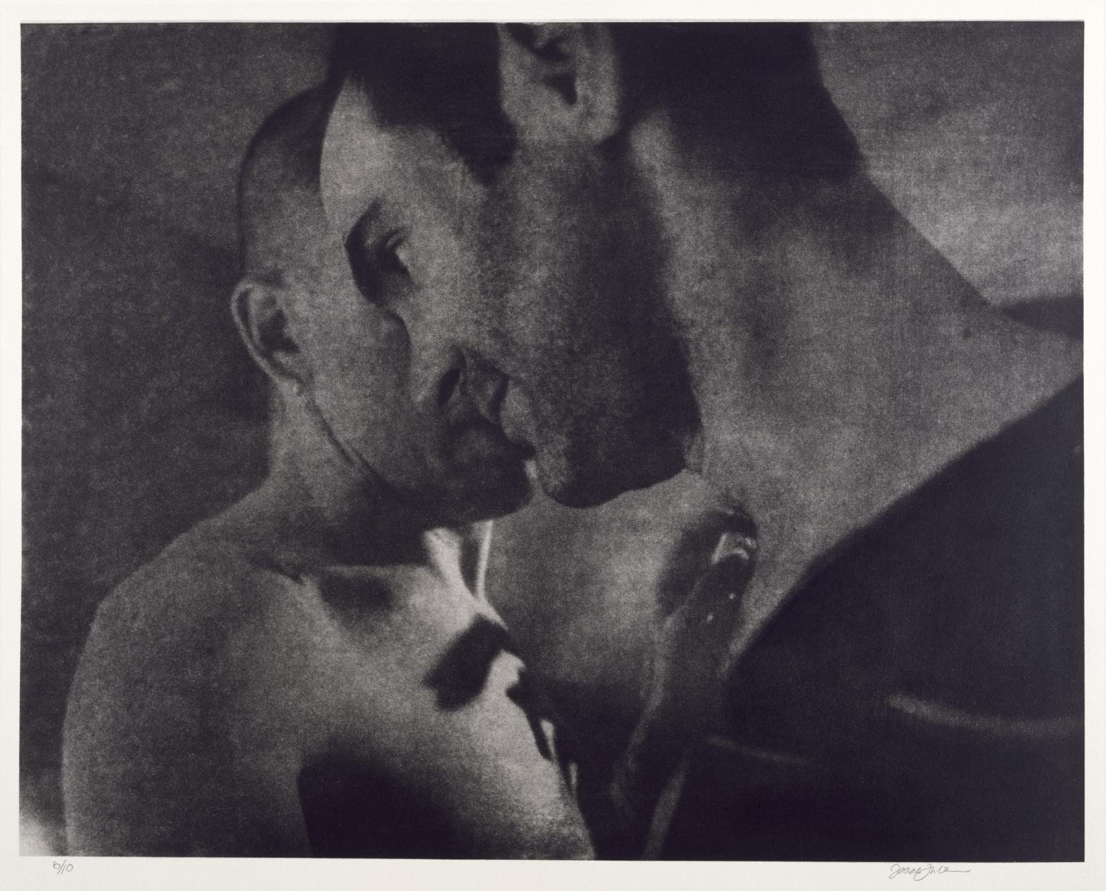 A dark image of two masculine-looking people lean in to each other as if dancing or about to kiss.
