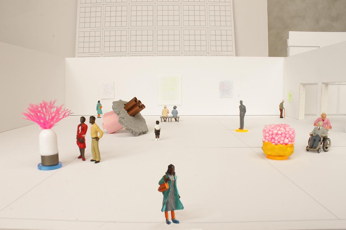 A black-and-white model of an MCA gallery with colorful figurines of people and artworks.