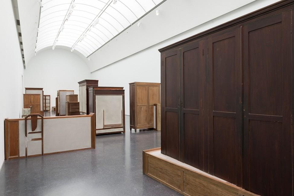 A room holds several wooden furniture pieces, each filled with cement.