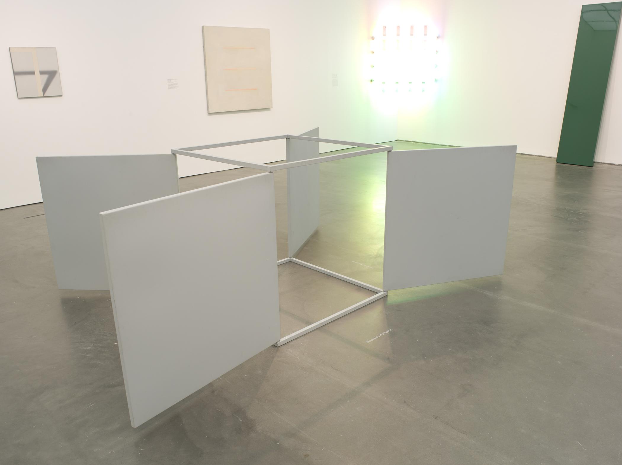 Gallery view of minimalist sculptures and paintings