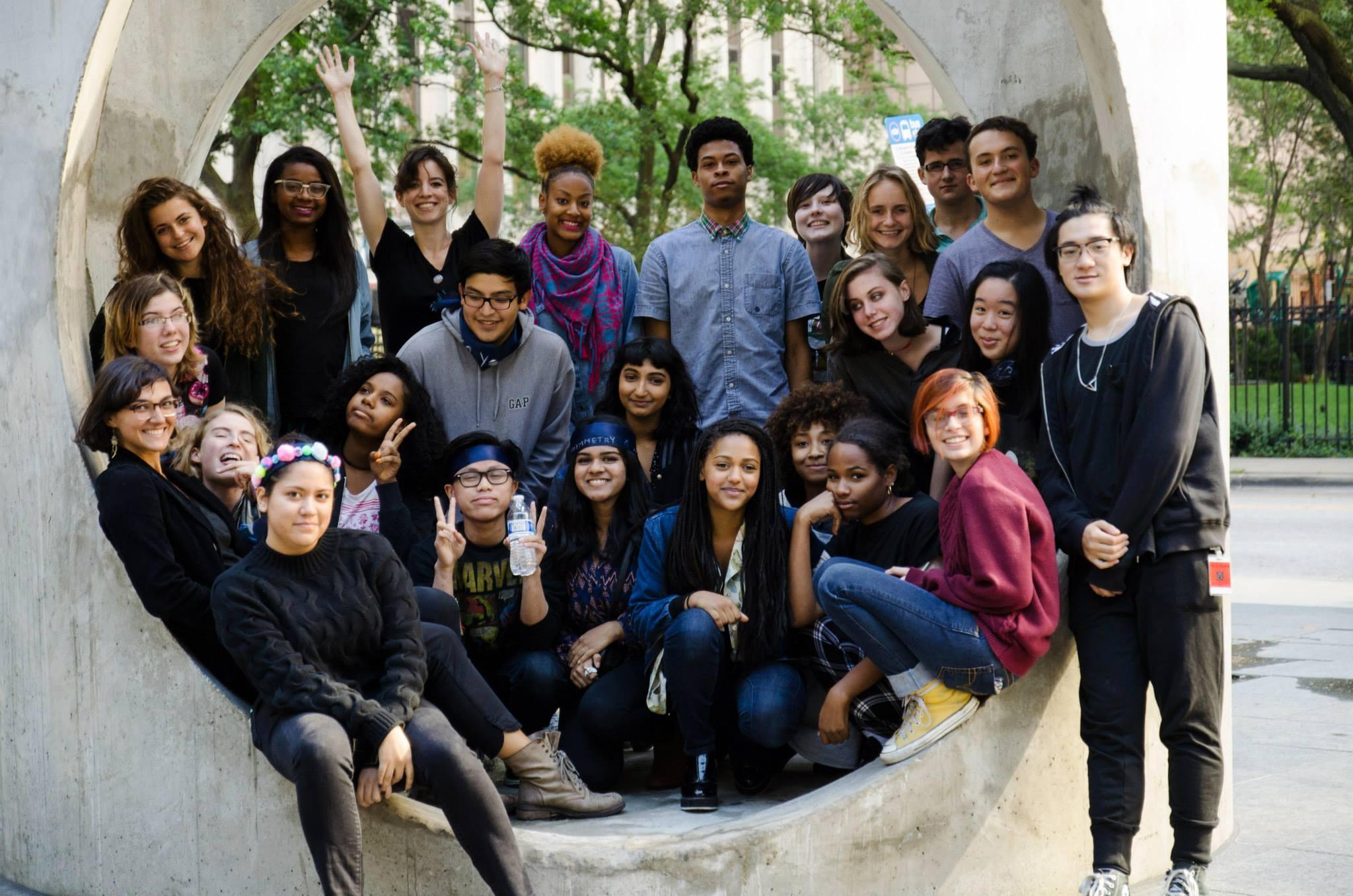 Over a dozen TCA members gather and pose inside of Alexandre da Cunha's *Figurehead* sculpture.