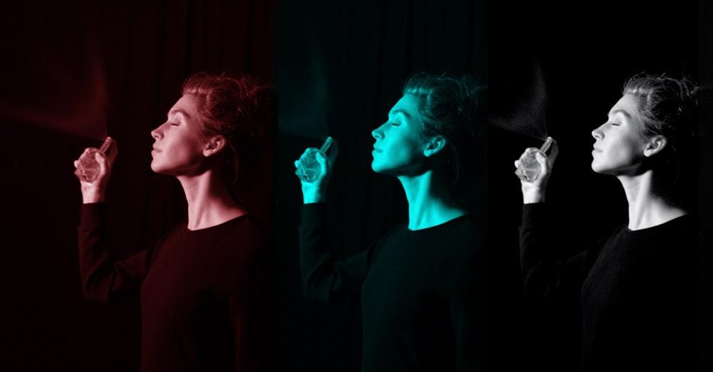 The profile of a woman with closed eyes spraying a perfume bottle away from her face is repeated three times, each in a different hue, against a black background.