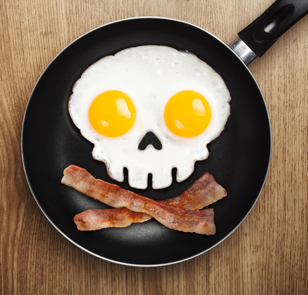 A black frying pan serves up a skull and crossbones made from eggs and bacon.