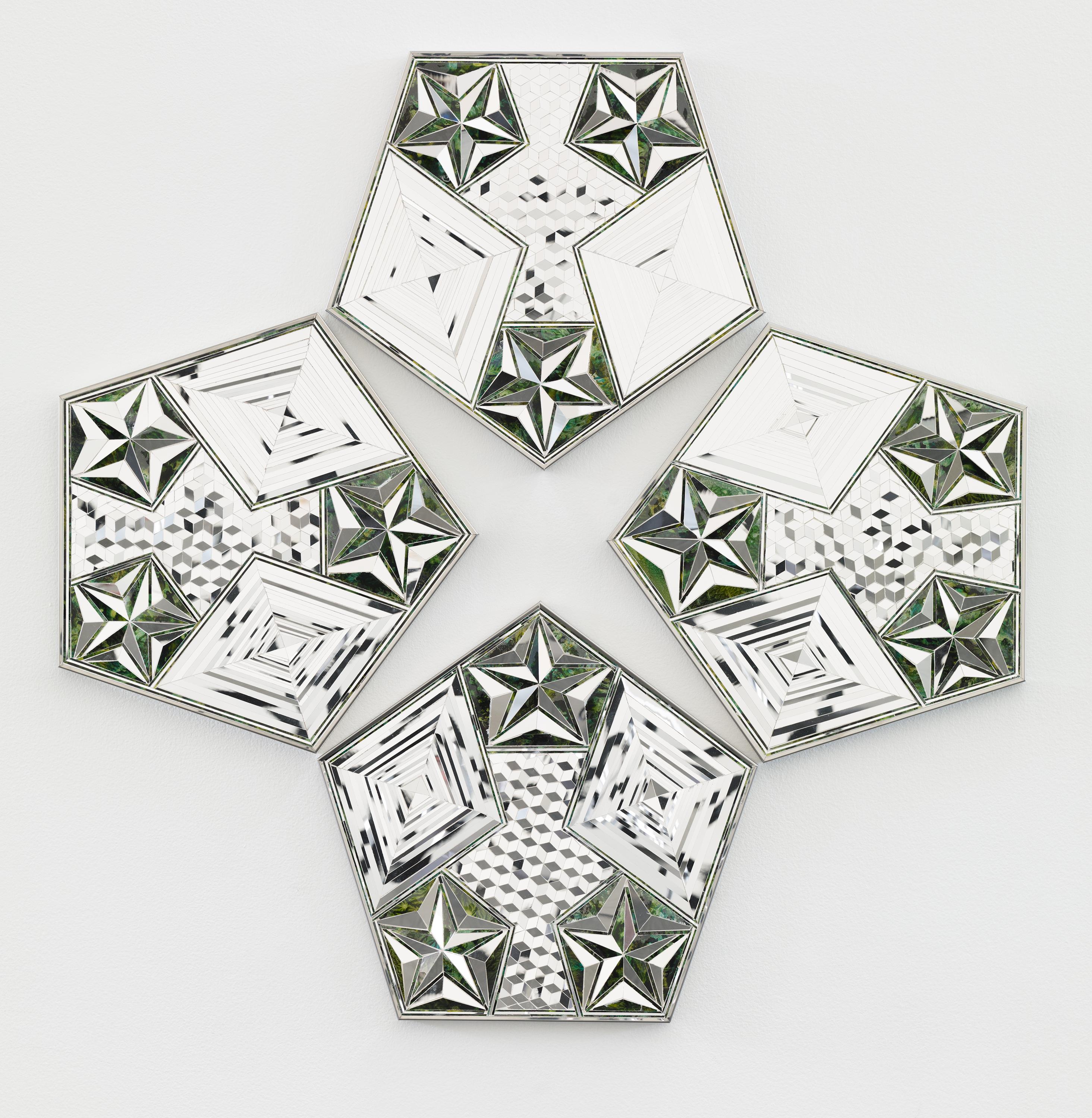 Four pentagons with geometric patterns made out of mirror shards hang on a wall.