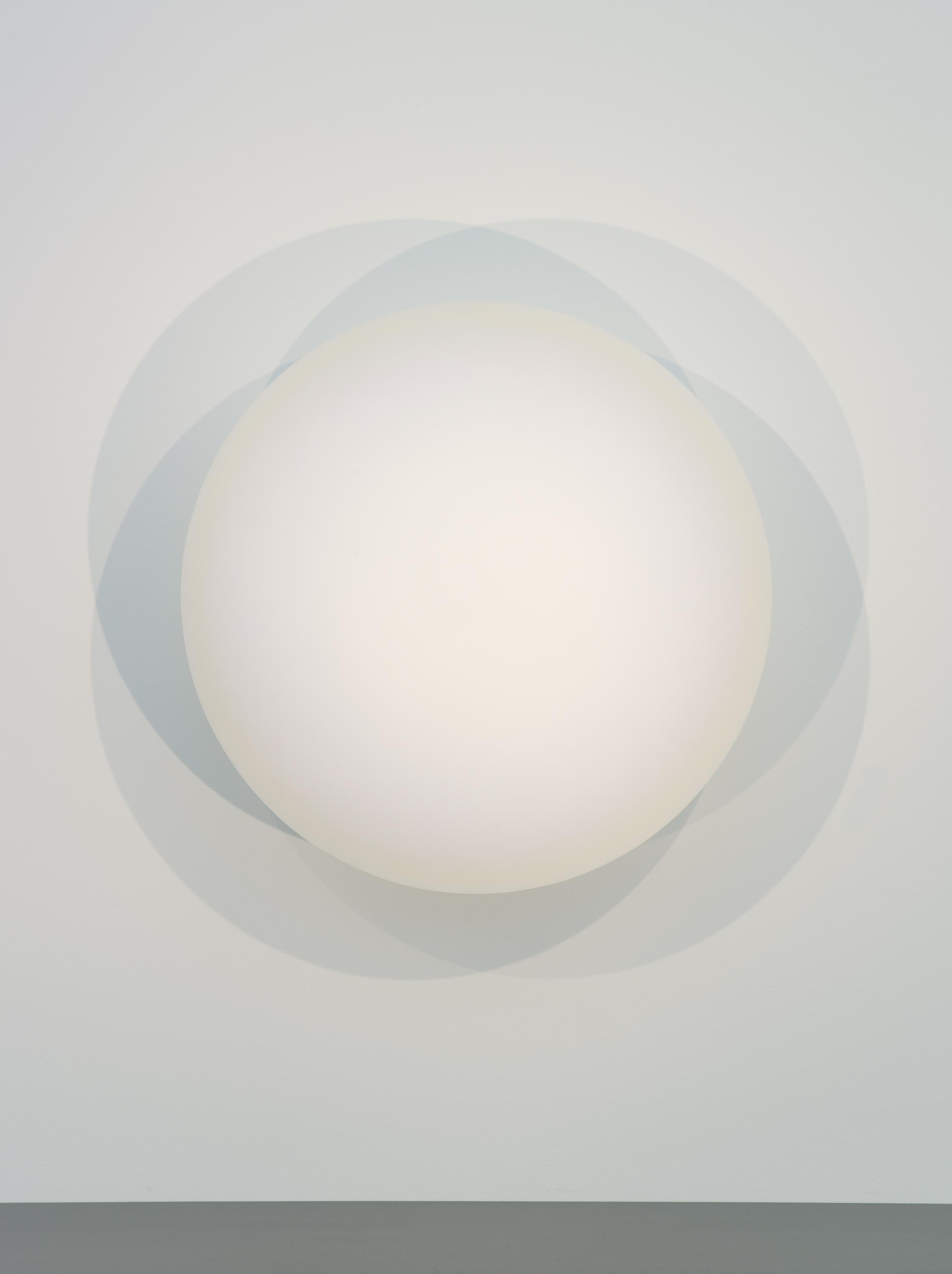 A glowing white sphere casts shadows on a white wall.