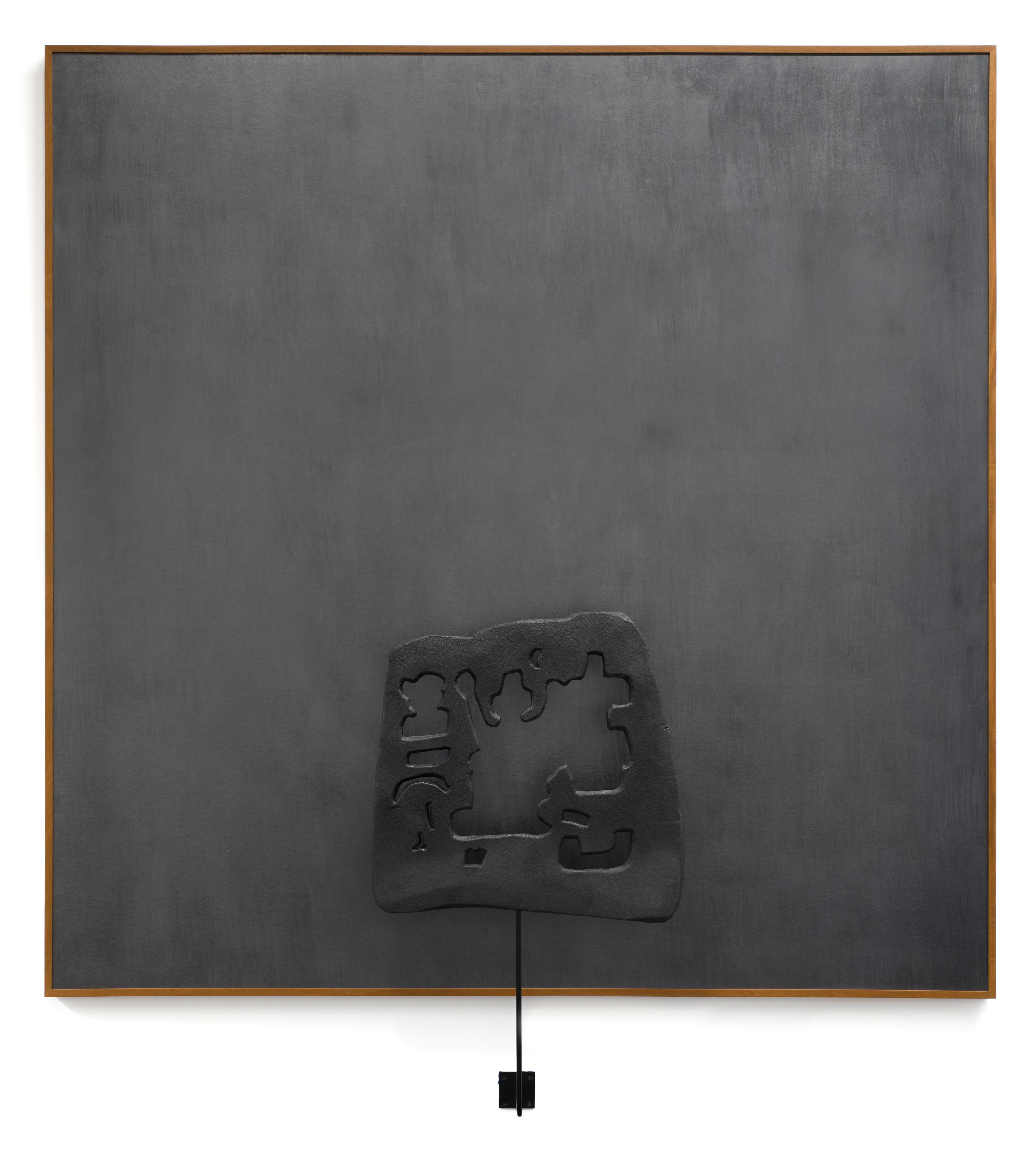 a square frame filled with a uniform dark matte gray with a metal sculpture affixed