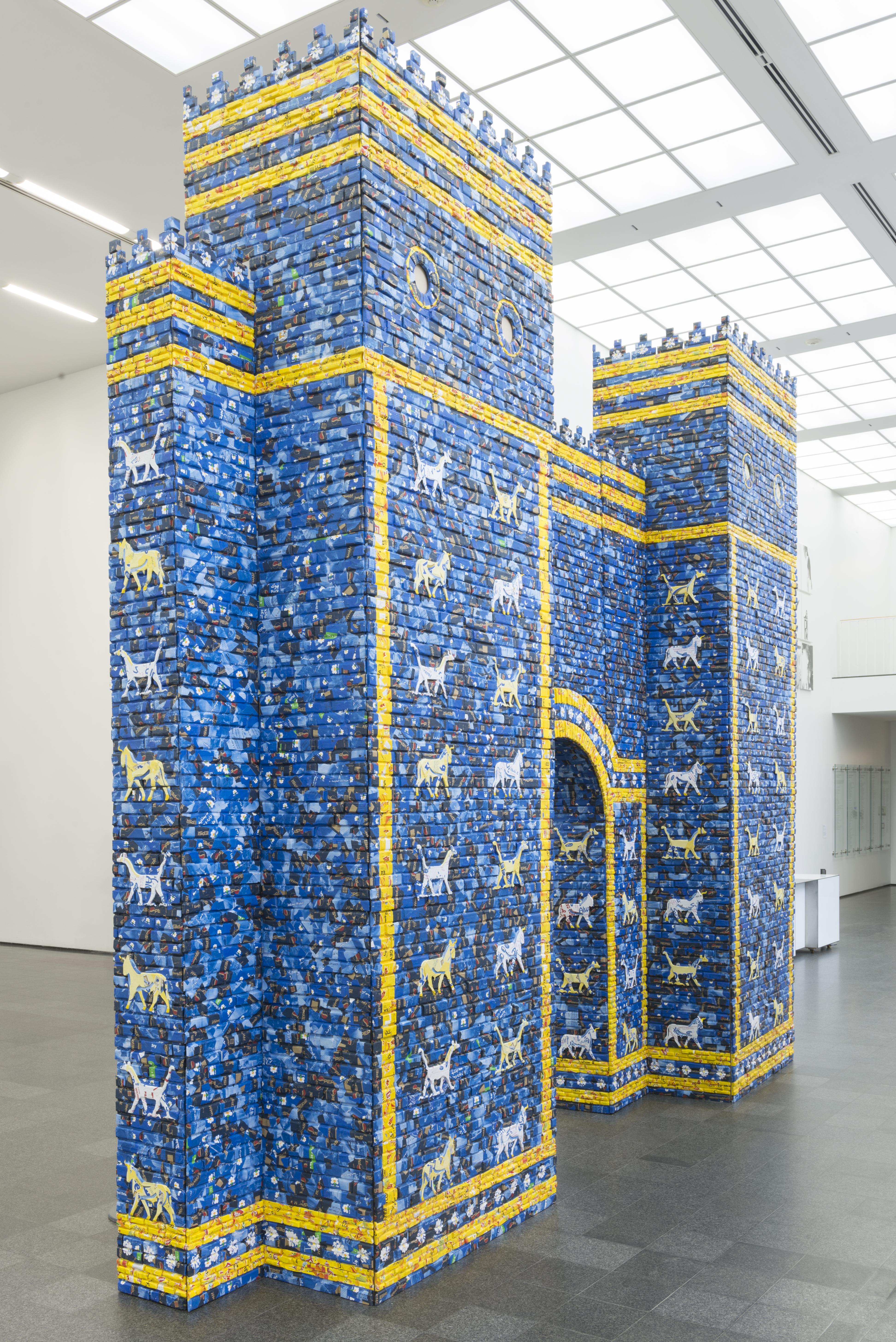A blue and yellow castle-like structure stands in the MCA atrium