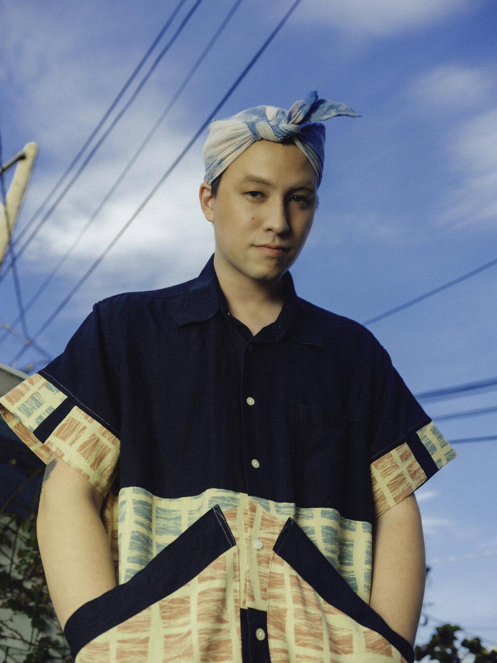 A photograph of Sen Morimoto set against a blue sky