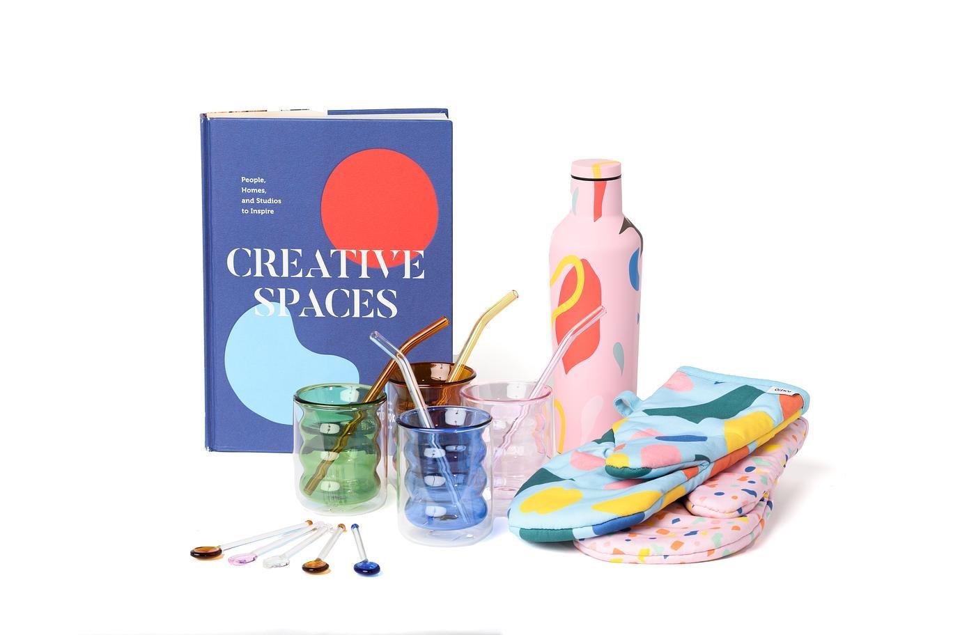 MCA Store merch including the book 'Creative Spaces', colorful glassware and other kitchen items