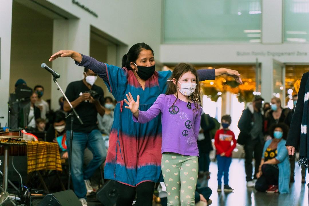 A child dancing with an adult during an MCA event
