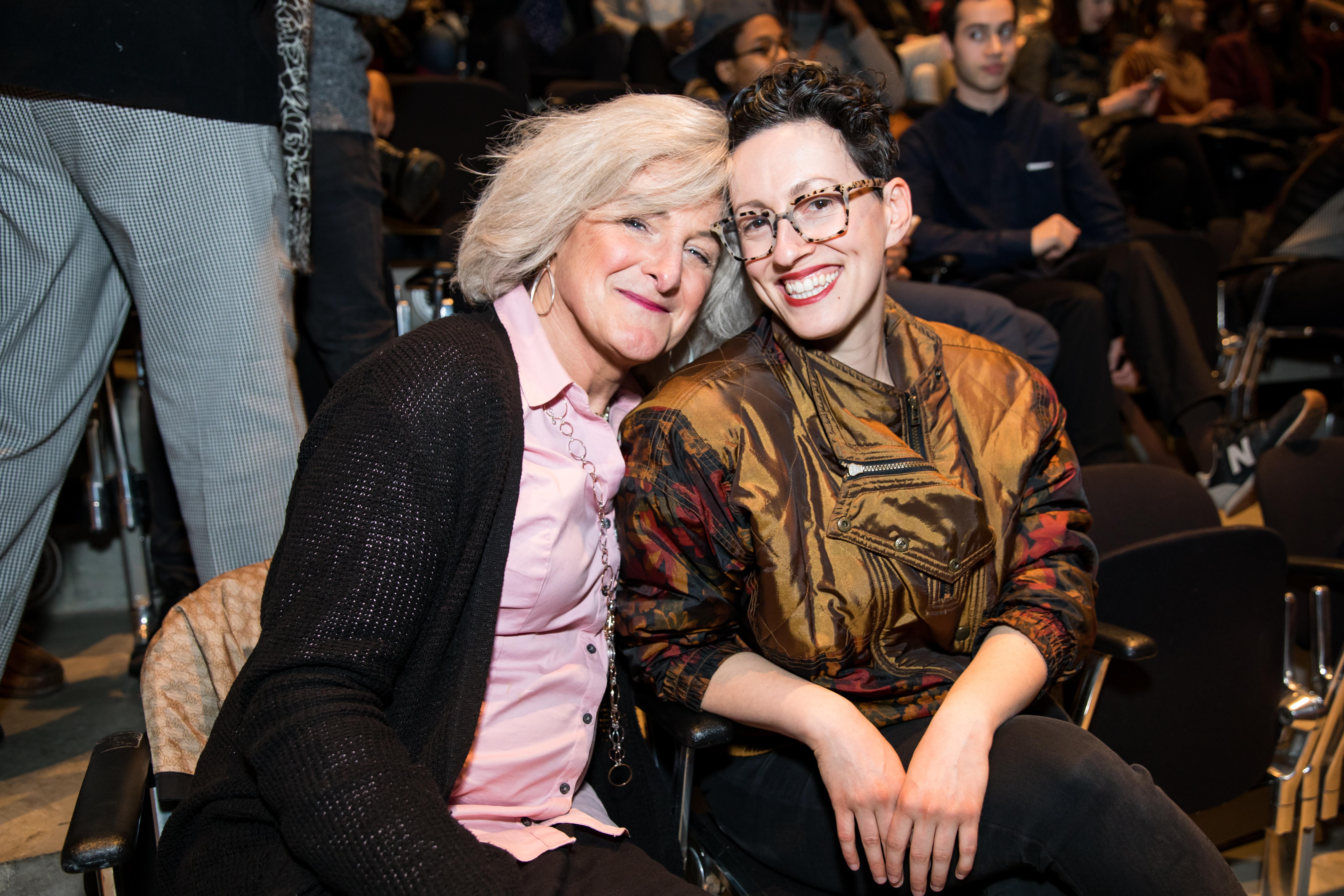 Two white women smile into the camera.