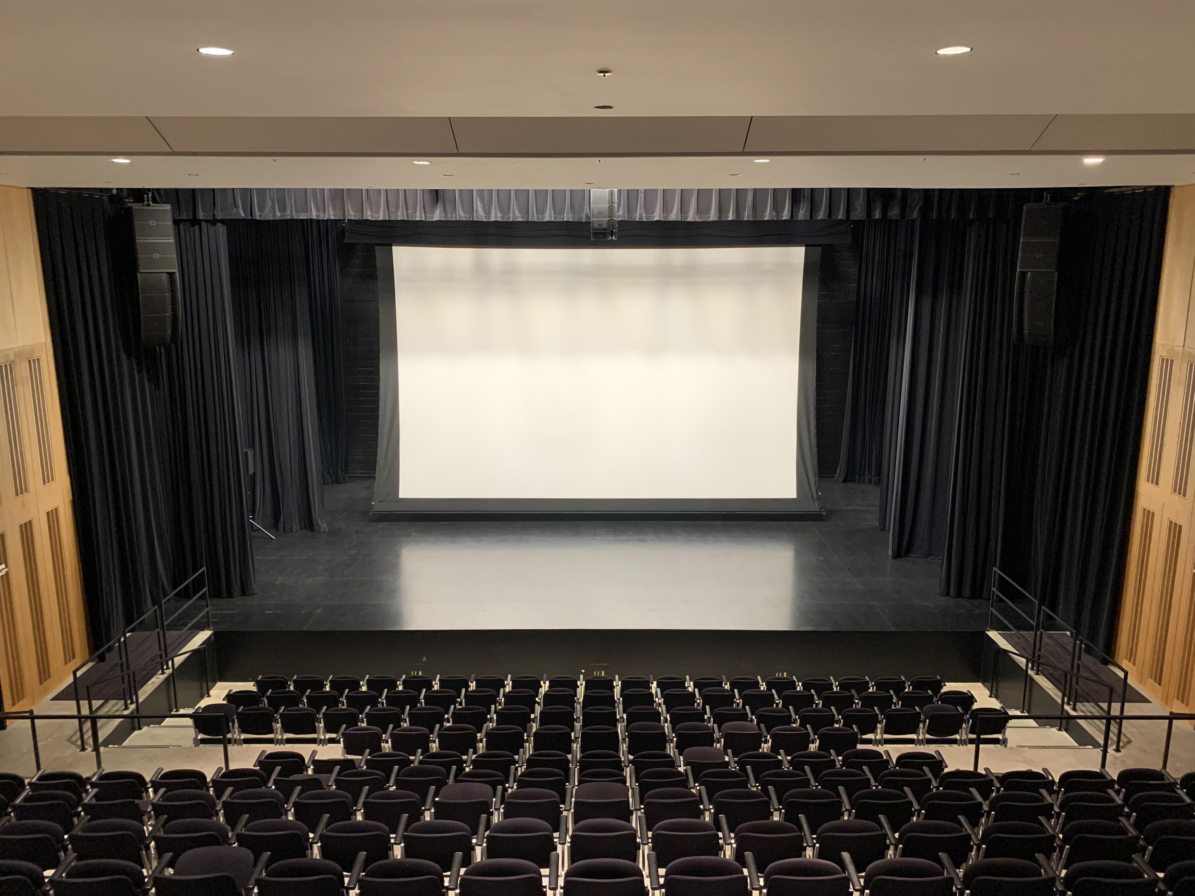 Theater with screen hanging over stage